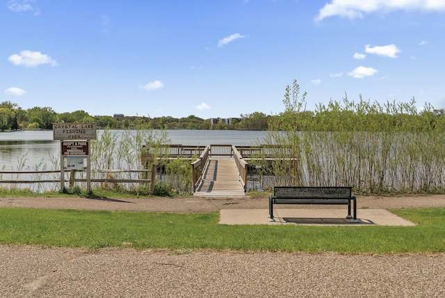 dock area with a water view and fence
