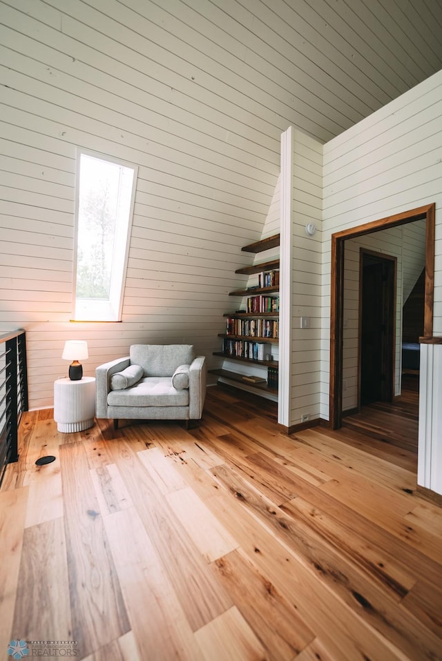 21574 State 200, Rice Twp, MN 56621 - sitting room with wooden walls and hardwood / wood-style flooring