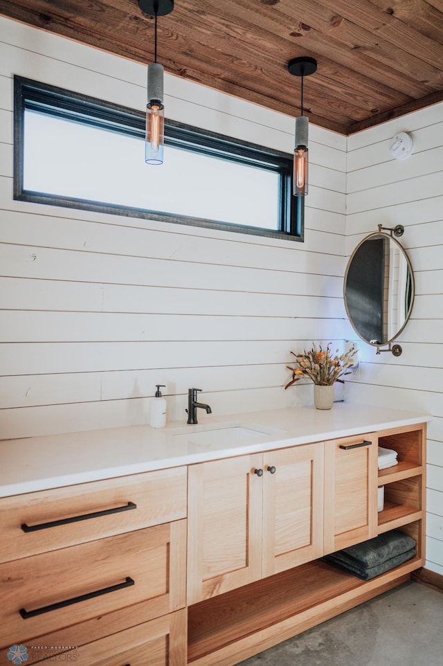 21574 State 200, Rice Twp, MN 56621 - bathroom featuring vanity, wooden walls, concrete floors, and wooden ceiling