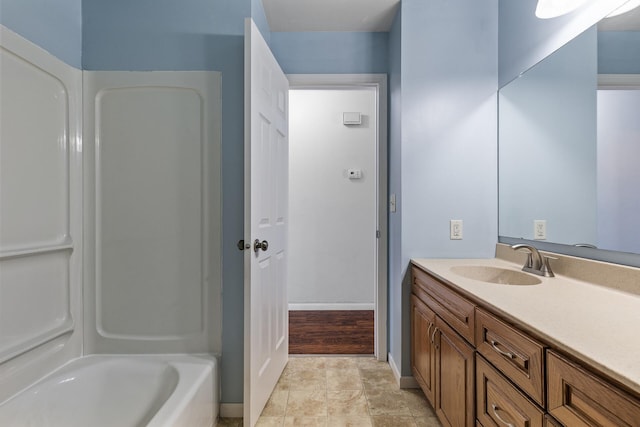full bath with vanity and baseboards