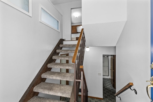 stairway featuring baseboards