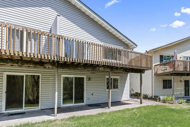 back of house with a patio, a deck, and a yard