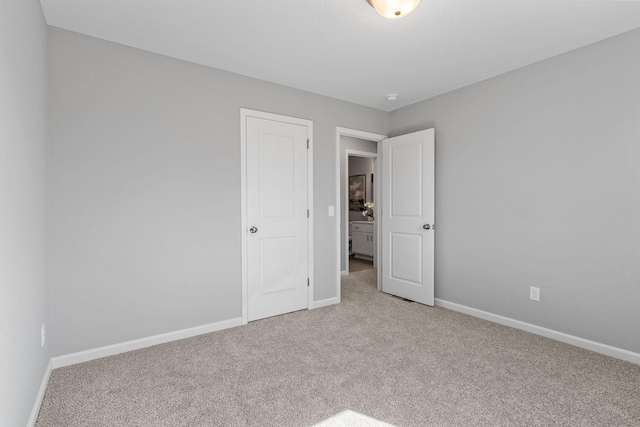 unfurnished bedroom featuring baseboards and carpet flooring