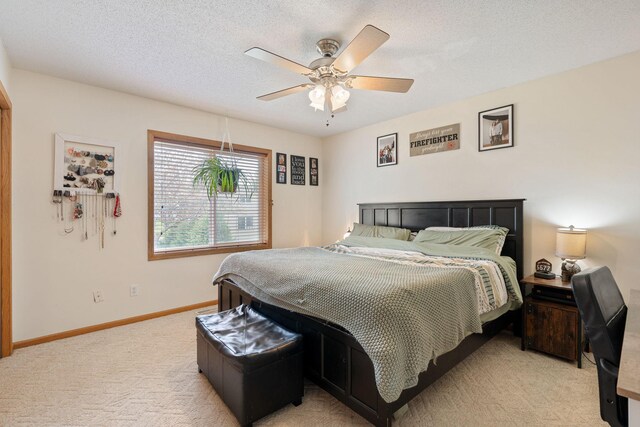 404 6th St NW, New Richland, MN 56072 - bedroom featuring light colored carpet, ceiling fan, baseboards, and a textured ceiling