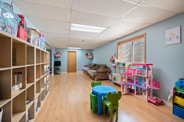 404 6th St NW, New Richland, MN 56072 - playroom with wood finished floors and a paneled ceiling