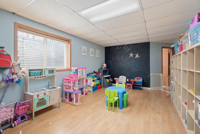 404 6th St NW, New Richland, MN 56072 - playroom featuring a drop ceiling and wood finished floors
