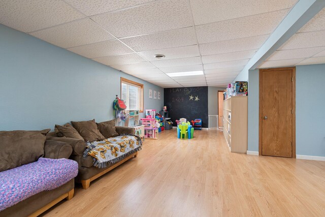 404 6th St NW, New Richland, MN 56072 - rec room featuring a drop ceiling, wood finished floors, and baseboards