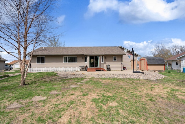 404 6th St NW, New Richland, MN 56072 - rear view of house with a storage shed, an outbuilding, a yard, and a shingled roof