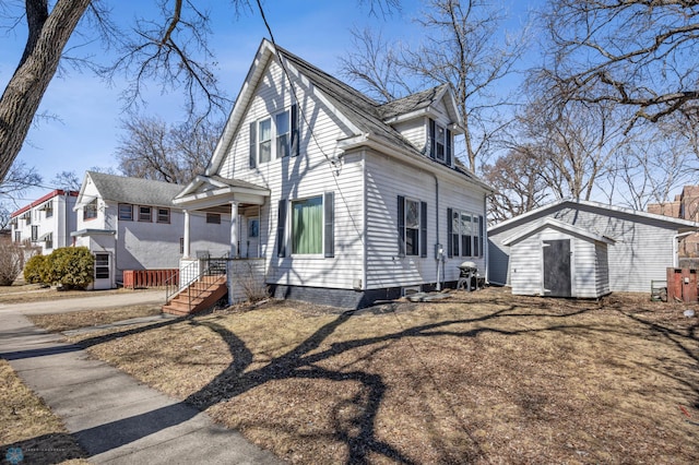 view of front facade featuring an outdoor structure, a storage shed, and a residential view
