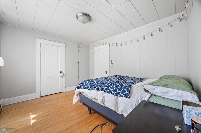 bedroom featuring baseboards and wood finished floors
