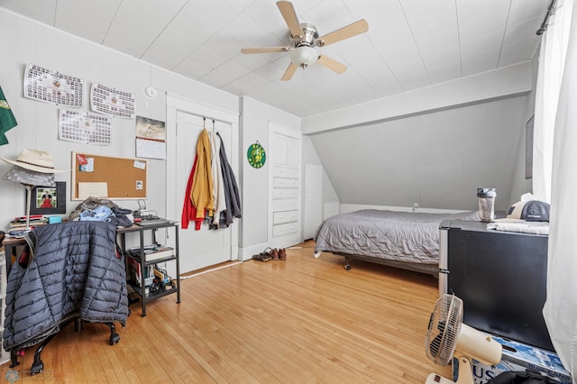 bedroom with lofted ceiling, a ceiling fan, and hardwood / wood-style flooring