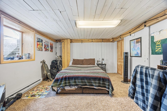 bedroom featuring a baseboard heating unit, wooden ceiling, and carpet