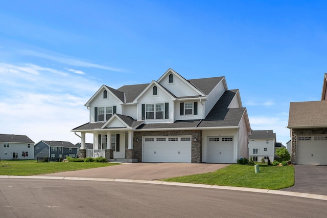 825 Spancil Hill Vw, Woodbury, MN 55129 - view of front facade featuring asphalt driveway, a front yard, an attached garage, a porch, and stone siding