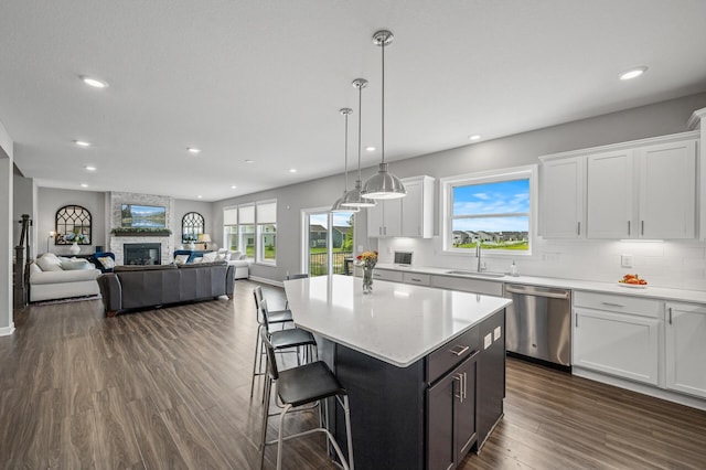 825 Spancil Hill Vw, Woodbury, MN 55129 - kitchen with stainless steel dishwasher, white cabinets, recessed lighting, a sink, and a kitchen bar