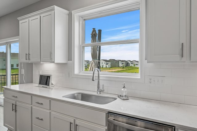 825 Spancil Hill Vw, Woodbury, MN 55129 - kitchen with stainless steel dishwasher, a sink, tasteful backsplash, and white cabinetry