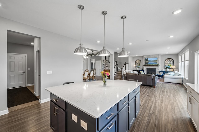 825 Spancil Hill Vw, Woodbury, MN 55129 - kitchen featuring dark wood-type flooring, a stone fireplace, recessed lighting, baseboards, and a center island