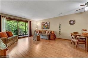 20 Windsor Ln Unit 303A, New Brighton, MN 55112 - living room featuring light wood-style floors and ceiling fan