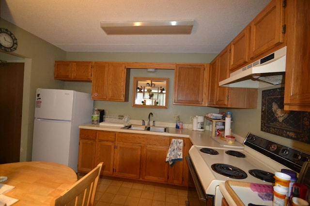 20 Windsor Ln Unit 303A, New Brighton, MN 55112 - kitchen featuring white appliances, under cabinet range hood, a sink, light countertops, and light tile patterned flooring