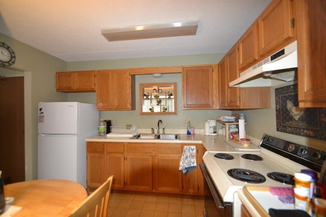20 Windsor Ln Unit 303A, New Brighton, MN 55112 - kitchen featuring white appliances, under cabinet range hood, a sink, light countertops, and light tile patterned floors