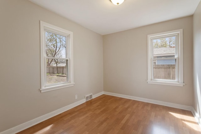 unfurnished room featuring light wood-style floors and baseboards