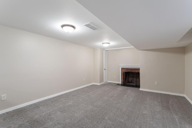 finished below grade area with a fireplace, carpet floors, and baseboards