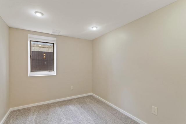 carpeted empty room with baseboards