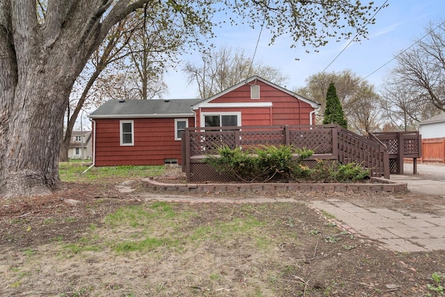 back of property with a wooden deck