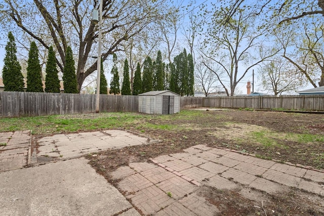 fenced backyard with a shed, a patio, and an outdoor structure
