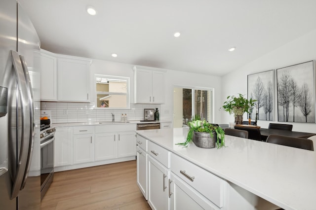 2336 Jandell Ave NE, Saint Michael, MN 55376 - kitchen with appliances with stainless steel finishes, a sink, backsplash, light countertops, and light wood-style flooring
