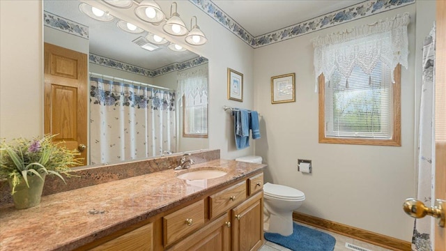 full bathroom with toilet, vanity, baseboards, and curtained shower