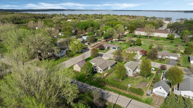 aerial view of property and surrounding area featuring a nearby body of water and nearby suburban area