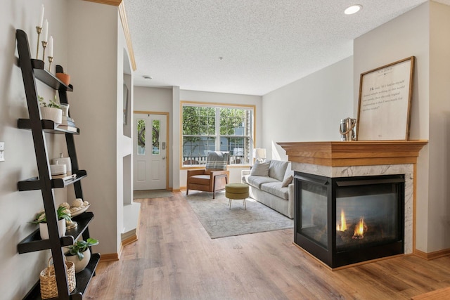 13700 54th Ave N Unit 405, Plymouth, MN 55446 - living room with a textured ceiling, wood finished floors, a fireplace, and baseboards