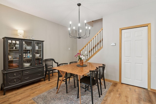 13700 54th Ave N Unit 405, Plymouth, MN 55446 - dining room with light wood finished floors, a chandelier, and stairway