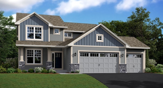 view of front facade with board and batten siding, an attached garage, a shingled roof, a front yard, and aphalt driveway