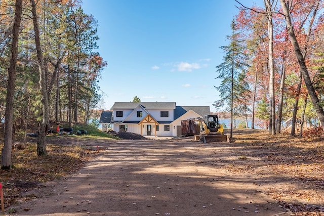 modern farmhouse style home with dirt driveway