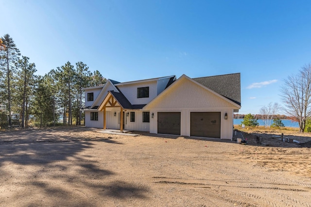 modern farmhouse style home featuring driveway and a garage