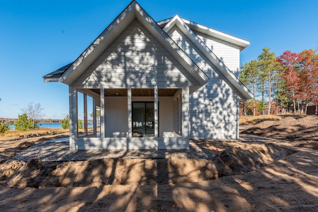 rear view of property with a porch