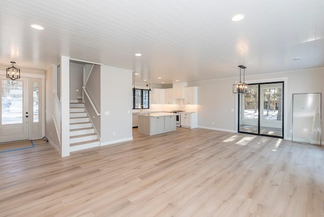 unfurnished living room featuring a chandelier, plenty of natural light, baseboards, recessed lighting, and wooden ceiling