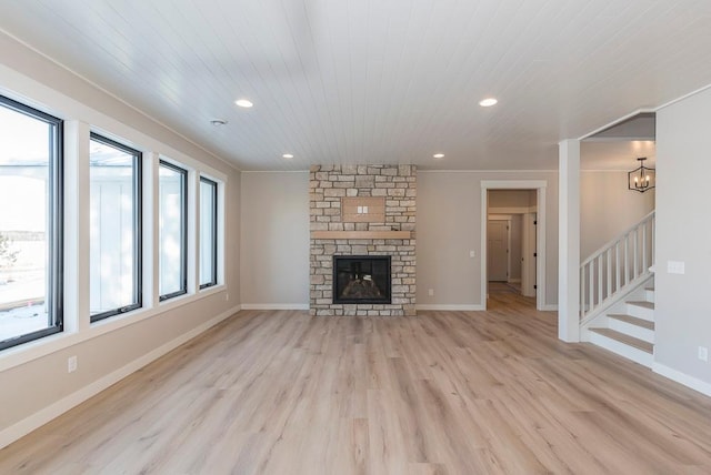 unfurnished living room featuring light wood-style floors, stairway, wooden ceiling, recessed lighting, and a chandelier