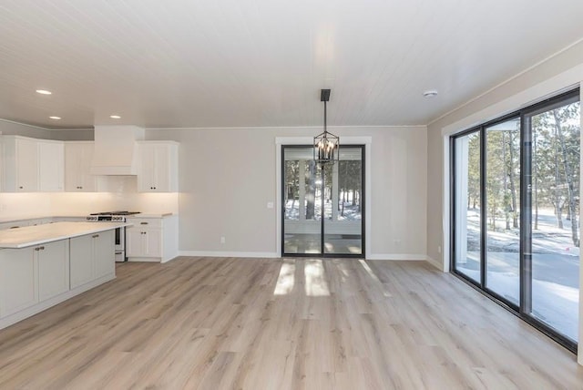 unfurnished dining area featuring light wood-type flooring, baseboards, and recessed lighting
