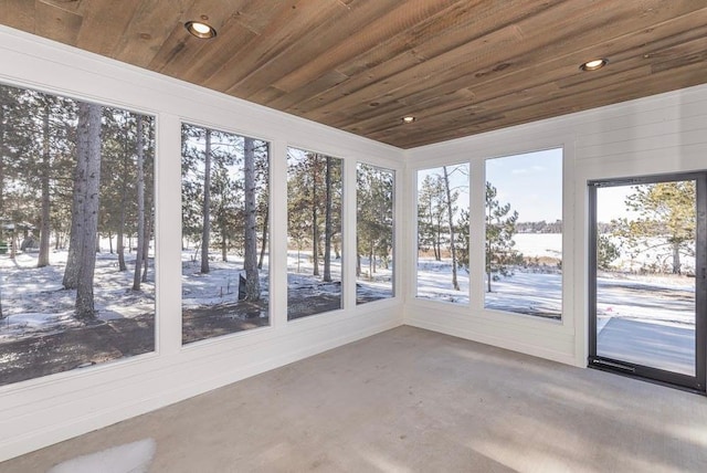 unfurnished sunroom featuring wooden ceiling, recessed lighting, and concrete flooring