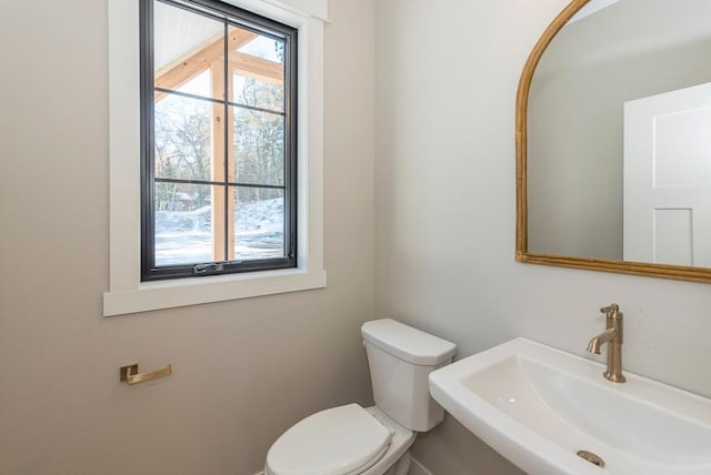 half bathroom with a sink and toilet