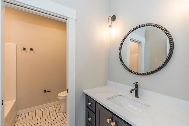 bathroom featuring toilet, vanity, baseboards, a bathtub, and a shower