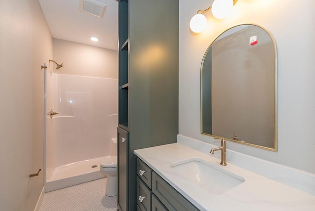 full bathroom featuring a shower, toilet, vanity, and tile patterned floors
