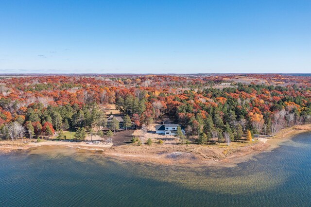 bird's eye view of a heavily wooded area and a nearby body of water