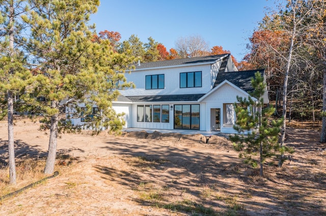 back of house featuring a shingled roof and a patio