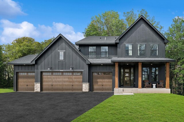 20090 63rd Ave, Corcoran, MN 55340 - modern farmhouse style home featuring asphalt driveway, a front yard, a shingled roof, a porch, and board and batten siding
