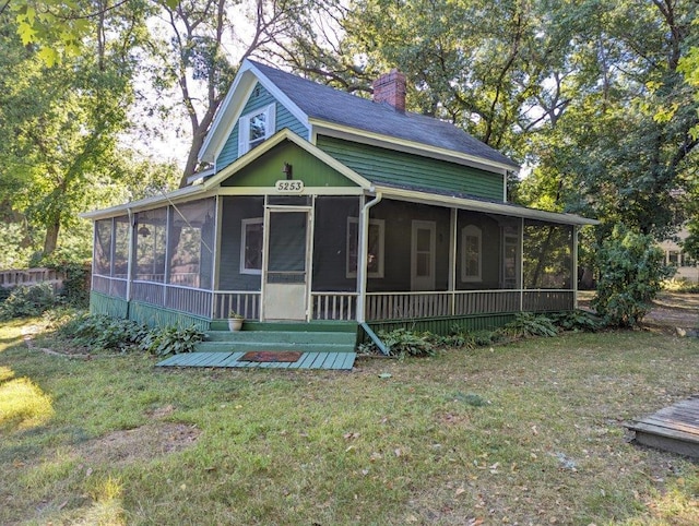 5253 Bald Eagle Blvd, White Bear Twp, MN 55110 - farmhouse featuring a sunroom, a chimney, and a front lawn