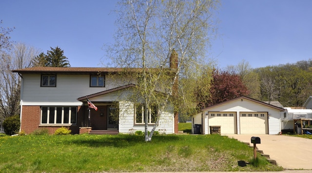 traditional home featuring concrete driveway, brick siding, and a front yard