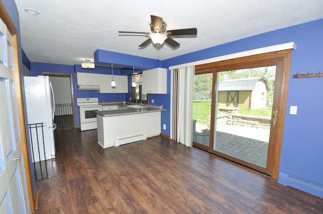 kitchen with white appliances, baseboard heating, a peninsula, white cabinets, and dark wood-type flooring